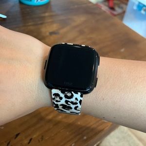 Black Fitbit Versa with 2 bands